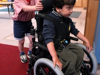 Samuel Habib, 3, uses his wheelchair with friend Jason Bogacz, 4 at Shaker Road School.    Dan Habib photo