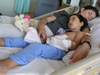 Samuel Habib rests with his mother, Betsy McNamara soon after Samuel, then 3, had a g-tube inserted into his stomach to improve his ability to take in foods and medicine.  Dan Habib photo