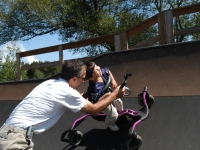 Samuel and his father, Dan Habib, ride the half-pipe of a skate park in Hopkinton, NH, with the help of Samuel's "Bronco" walker.  Dan Habib photo