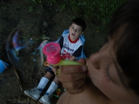Samuel and Isaiah play with bubbles near a local pond.  Dan Habib photo