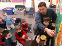 Samuel leads his friends in a morning lesson with the help of his pre-kindergarten teacher Justin Paul.
