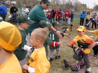 Samuel shakes hands with the other team after his first ever t-ball game at Frisbee Field in Concord.  (Dan Habib/Concord Monitor)