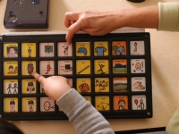 Samuel works with speech therapist Barbara Jobin on his "Tech-Talk" machine at Shaker Road School.  Dan Habib photo