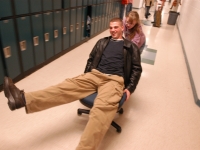 Alana Malfy pushes a student on a chair down the hallway. Dan Habib photo