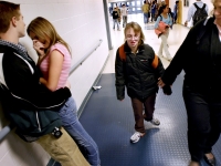Alana walks with her aide through the hallways of Pembroke Academy near other students.  Dan Habib photo