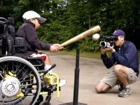 Samuel Habib, 7, sits in his power-assist wheelchair and smacks a t-ball off of a batting T.  His father, filmmaker Dan Habib, videotapes him with a Canon XL1S MiniDV Digital Camcorder in their Concord, NH, driveway. While making the film INCLUDING SAMUEL, Habib says he continually asked himself, "When do I play filmmaker? When do I just play with my kids?"   MANDATORY CREDIT: Photo by Isaiah Habib (Samuel's brother, age 11), August, 2007. From the film, Including Samuel, www.includingsamuel.com