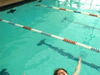 Emily Huff swims in the Concord Racquet Club pool  near a group of younger kids. "It's a relief of tension," she said.  "All my cares float away.  It shuts out the both reality and the inner world.   Dan Habib photo