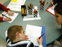 Inclusion facilitators, student teachers and specialists support the classroom teachers at Haggerty so that all students can access the general education curriculum. Classroom para-professional Allison DiDomenico works with Nathaniel during a writing exercise.   Dan Habib photo