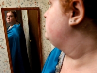 Emily Huff looks in the mirror wearing a cape she just made. “It gives me courage,” she said.