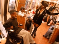Keith Jones chats with a woman on the "T" subway as he makes his way around his home town of  Boston.  Dan Habib photo